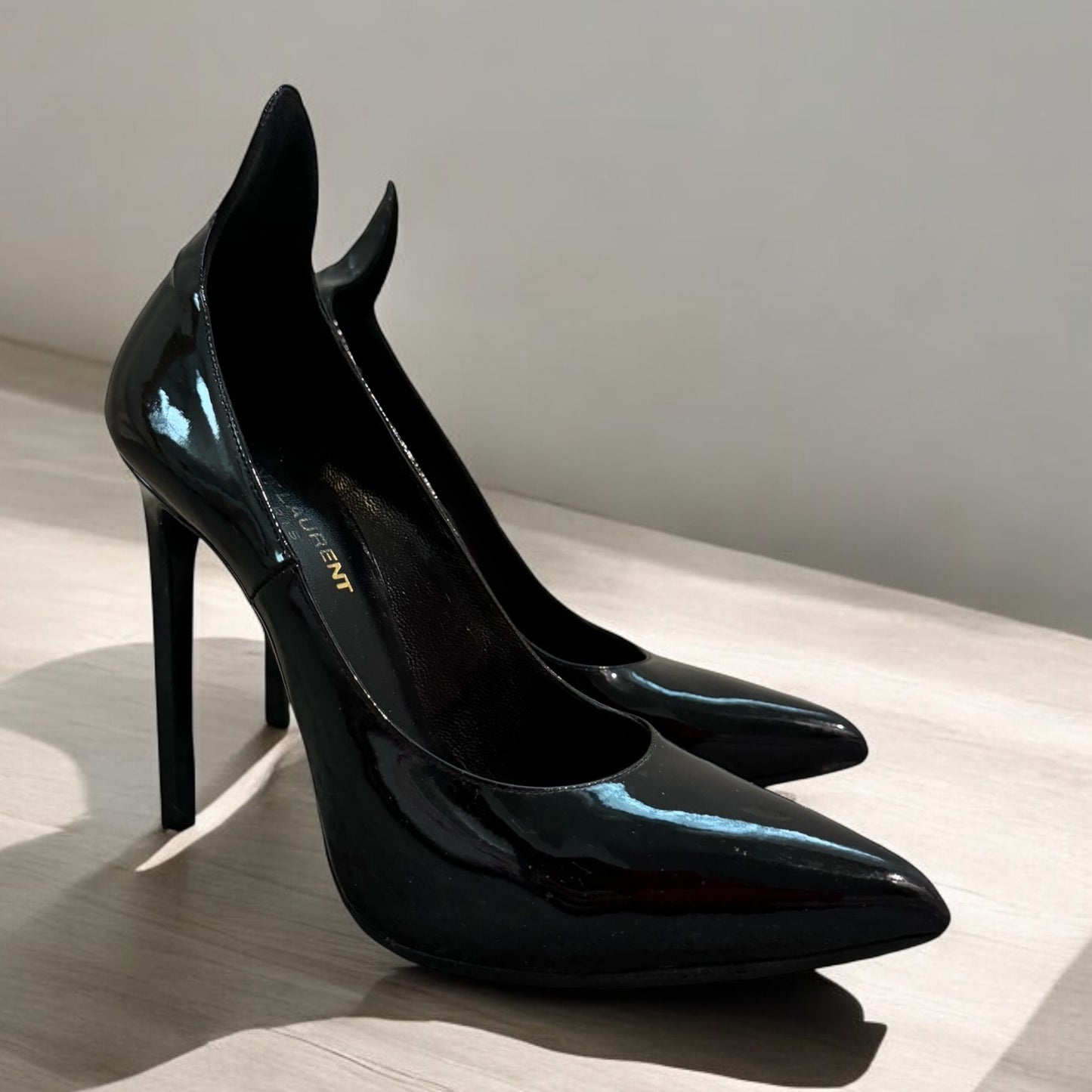 Saint Laurent Black Patent Leather Pumps
- Bold Elegance